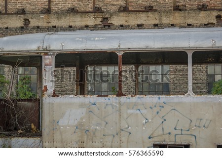 Old demolished rail bus in front of the old brick workshop building