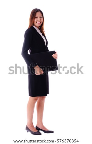 Smiling attractive asian business woman holding notebook or laptop on white background.