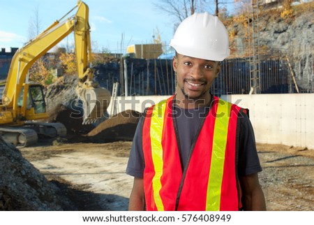 young construction worker foreman working on site, white helmet