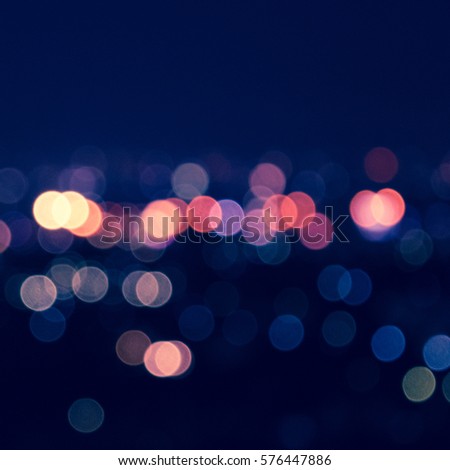 bokeh city blurred lights abstract circular defocused blue background with twilight horizon