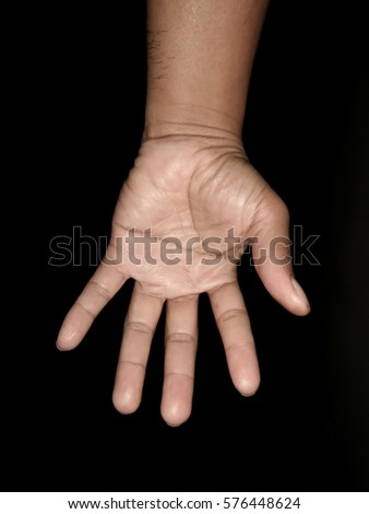 Male hand is showing five fingers on black background