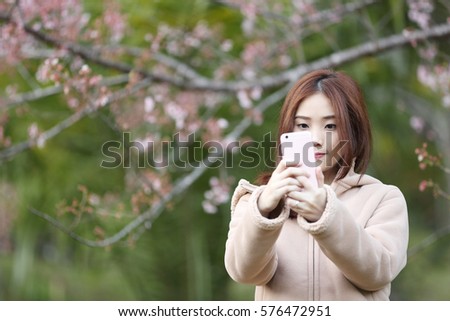 Asian woman selfie with cherry blossom sakura