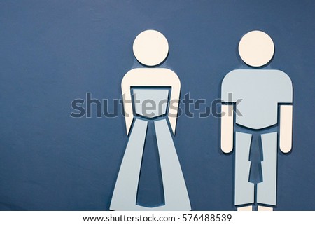 Toilet symbols on the blue wallpaper