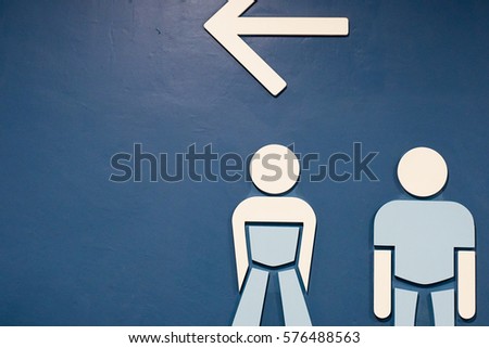 Toilet symbols on the blue wallpaper