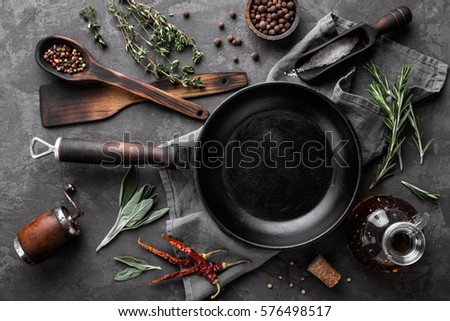 dark culinary background with empty black pan and space for text recipe or menu Royalty-Free Stock Photo #576498517