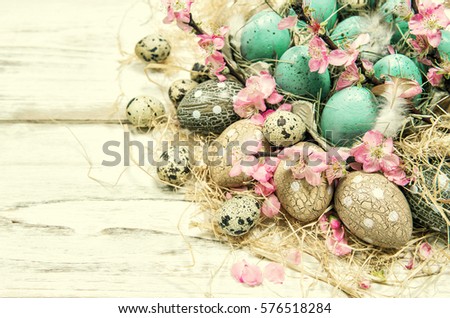 Easter decoration with blue eggs and pink flowers. Vintage style toned picture