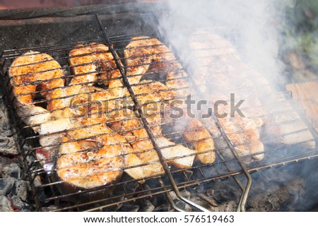 fish barbecue, fish cooking over charcoal