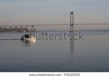 Fishing Boat on Little Belt and bridge in the background.Denmark.