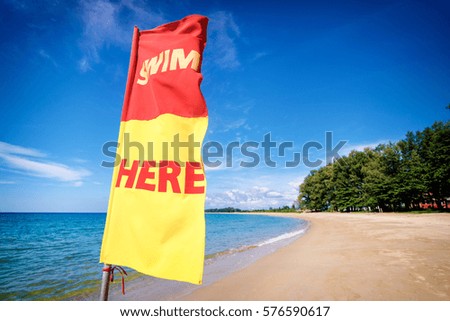 Swim here. Safety flag on the sea beach.