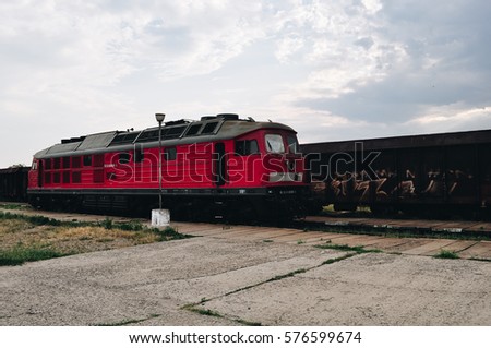 Old red train, in the station, natural background, green and red, Romania