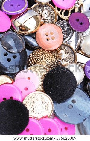 
Buttons background. Colored shiny clothing button texture. Colored sewing buttons pattern concept wallpaper. Mixed colors. Studio photo texture photography.