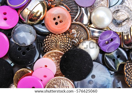 
Buttons background. Colored shiny clothing button texture. Colored sewing buttons pattern concept wallpaper. Mixed colors. Studio photo texture photography.