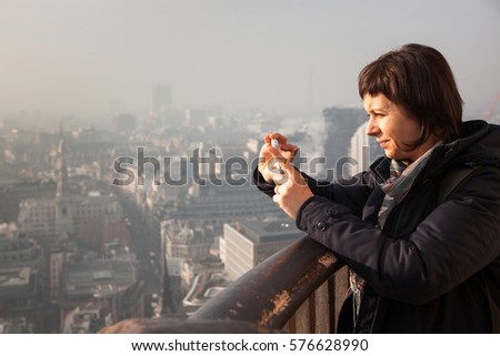 woman tourist on top of St Paul's cathedral, London, UK