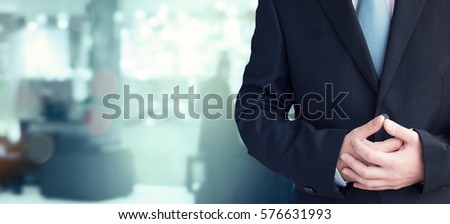 businessman with crossed arms pose, with blank copyspace area for text or slogan, against grey background