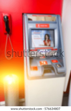 Photography of red cash dispenser