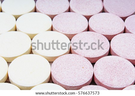 Stack of vitamin mineral supplement effervescent tablets pattern texture. Multivitamin supplement tablet. Soluble Vitamin. Fizzy tablet. Orange flavored effervescent tablets. 