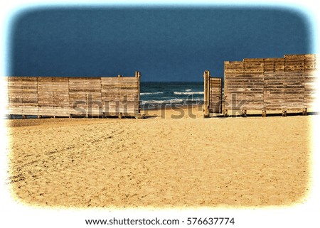 Wooden plank fence in the Israeli shore of the Mediterranean Sea. The wall separating the male and female religious part of the beach in Israel. Vintage style toned picture