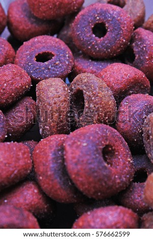 Dog pet food texture. Dog Meat food background pattern texture. Red round animal food.