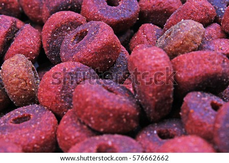Dog pet food texture. Dog Meat food background pattern texture. Red round animal food.