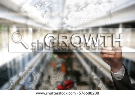 Businessman draws "Growth" on the virtual screen. Touch Screen. Virtual Icon. Graphs Interface. Business concept. Internet concept. Digital Interfaces