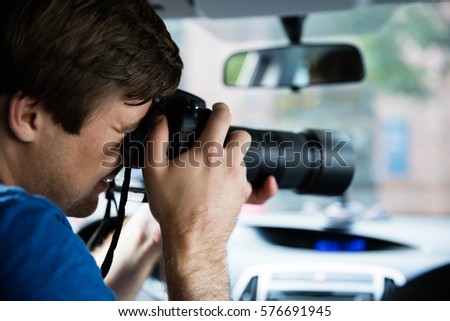 Man Sitting Inside Car Photographing With SLR Camera