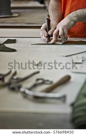 Man cutting leather