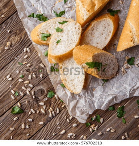 Picture of loaf with herbs on table with seeds
