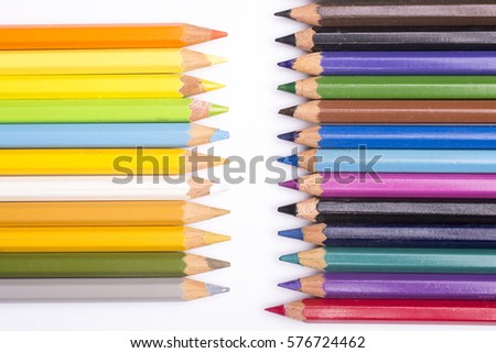 close up of various color pencils on white background