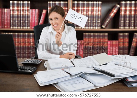 Female Accountant Holding Help Flag With A Pile Of Folders