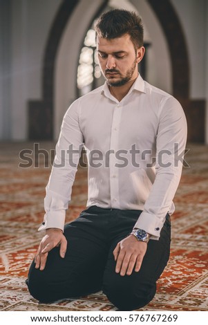 Muslim praying, kneeling and siting on the floor