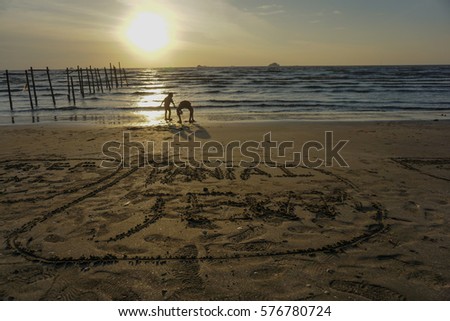 Children drawing on beach