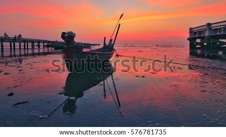 Sunset at sea with boat parked
