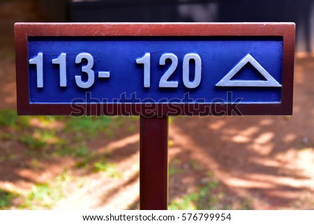 Sign showing direction to rooms 113 to 120.