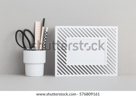 Photo frame and school supplies. Modern, stylish home decor mock up.