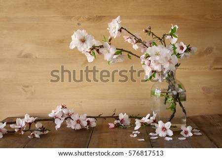 spring bouquet of cherry tree branches on the wooden table