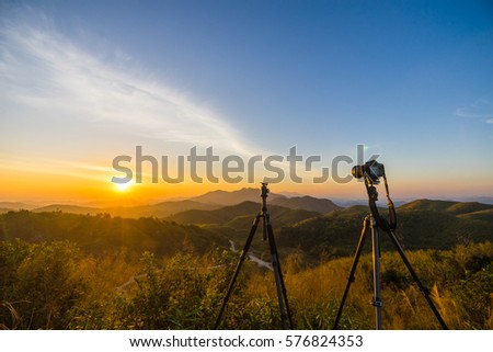 A photographer or traveller using a professional DSLR camera on a tripod