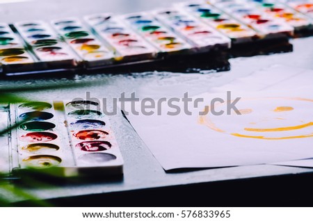 Paint lay on the black surface, pretty lights background, creativity