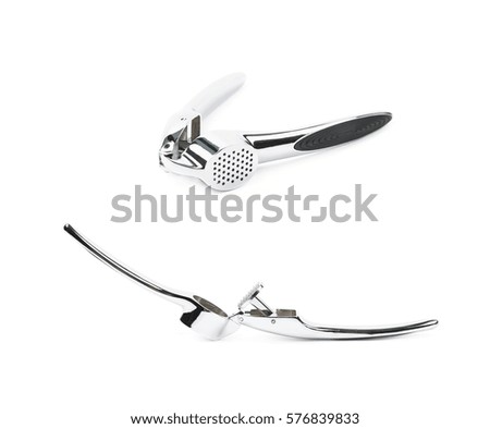 Metal garlic press utensil isolated over the white background, set of two different foreshortenings