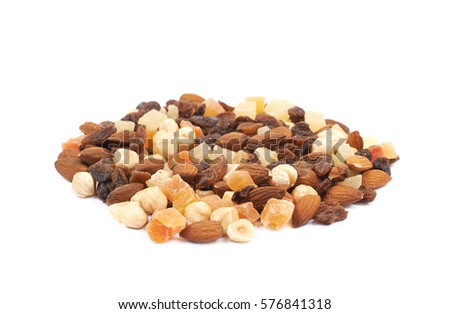 Pile of mixed nuts and dried fruits isolated over the white background
