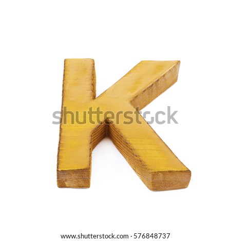 Single sawn wooden letter K symbol coated with paint isolated over the white background