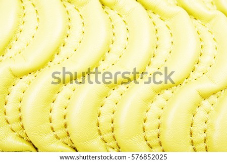 
Bag material leather faux leather texture. Quilted pattern as background, light soft green yellow.