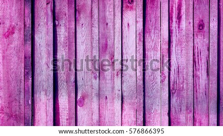 Vintage violet lilian pink fence with thin and wide vertical wooden planks with knots and paint spots. Seamless background texture of old white painted wooden lining boards wall