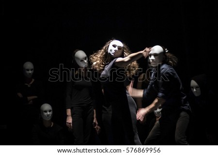 dynamic dance drama on stage in theater- theater group on stage  Royalty-Free Stock Photo #576869956