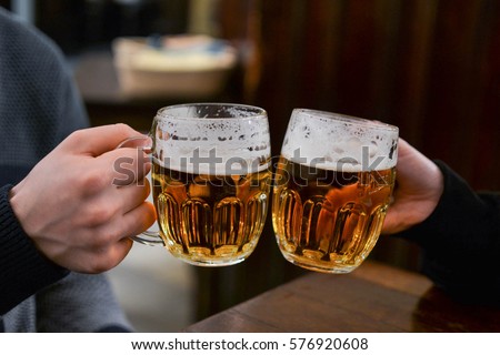 Friends having draught beer in Prague Royalty-Free Stock Photo #576920608