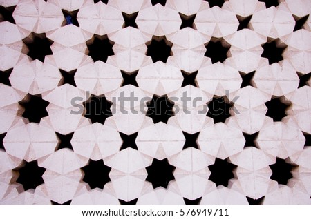 Stars on a white wall, background. Royalty-Free Stock Photo #576949711
