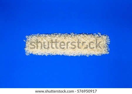 Basmati white uncooked rice on blue background. minimalism background isolated