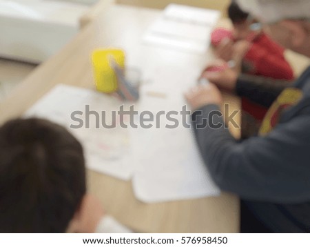 Blur background of helping kid to do homework 