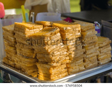 Stack of toast bread, Close up Slices of  toast bread and sugar butter on tray in local market, Thailand