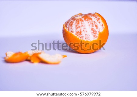 Peeled tangerine or mandrin fruit isolated on white background and in some bokeh (blur) mode.