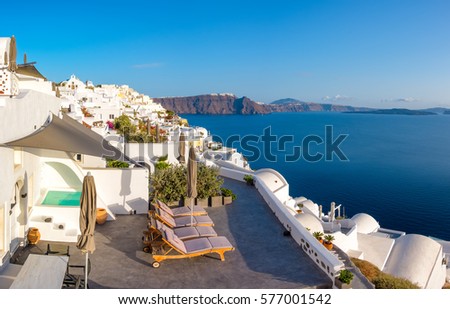 Beautiful Santorini in Greece - white apartments for tourists in Oia village, panoramic image